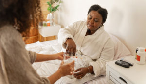 a woman giving a glass of water to a woman