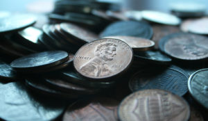 a pile of coins with a picture of a man on the side
