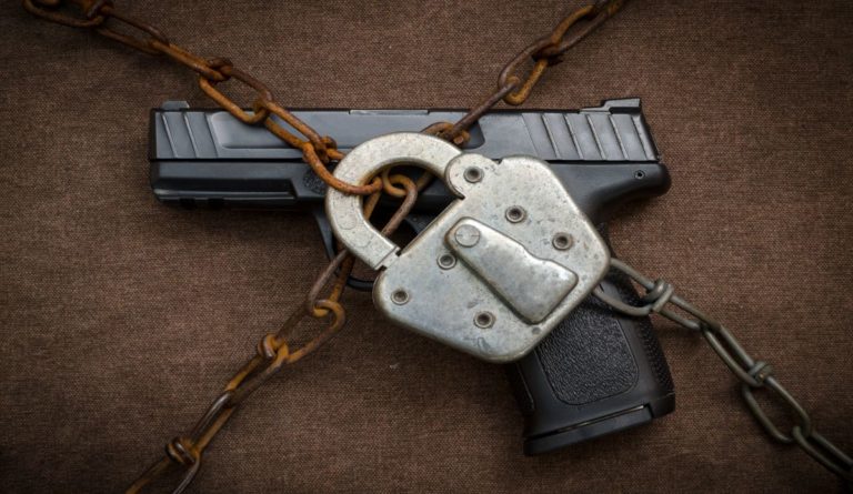 a gun with a lock and chain