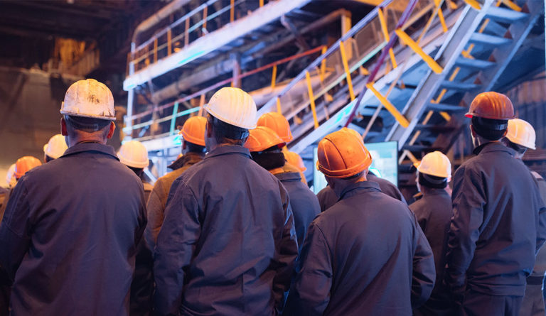 a group of people wearing hard hats