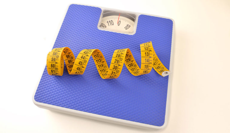 a scale with a yellow tape measure