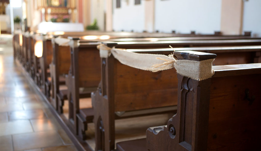 a wooden benches with a burlap ribbon