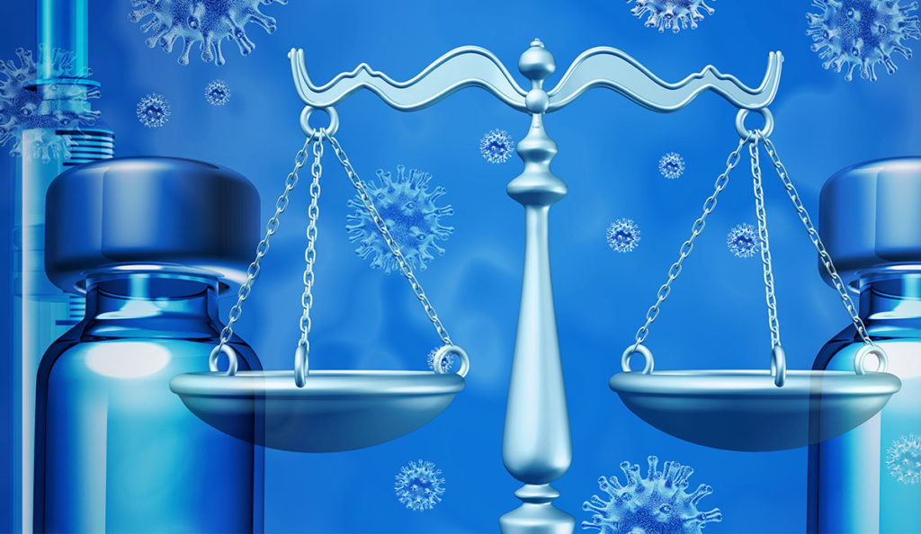 a scale of justice and a bottle of essential oil