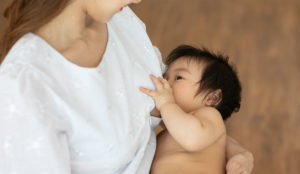 a woman breastfeeding a baby