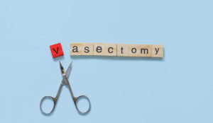 a pair of scissors and wooden blocks with letters