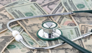 a stethoscope on top of money