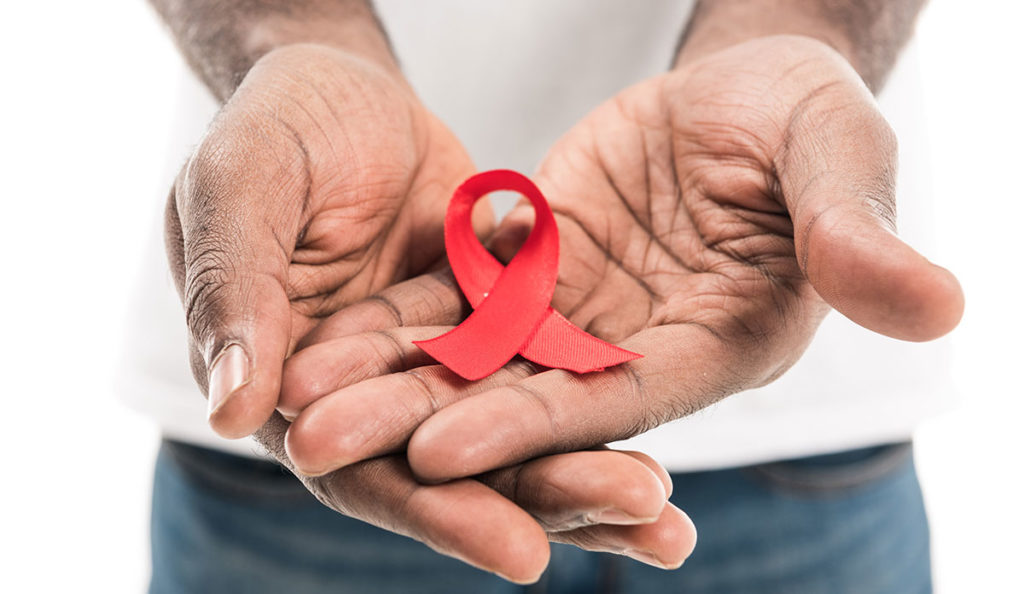 Hands holding red ribbon