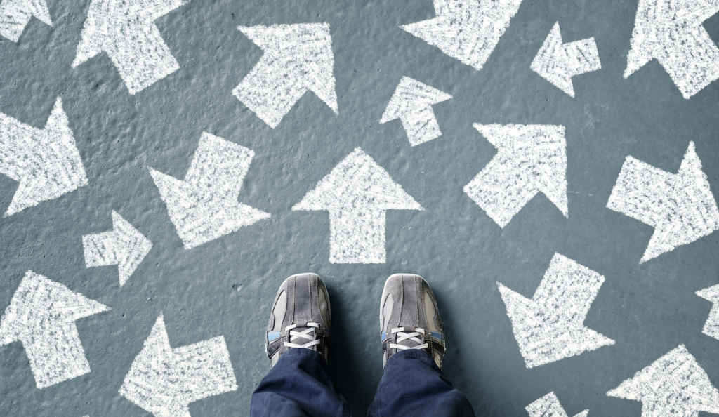 a person standing in front of arrows