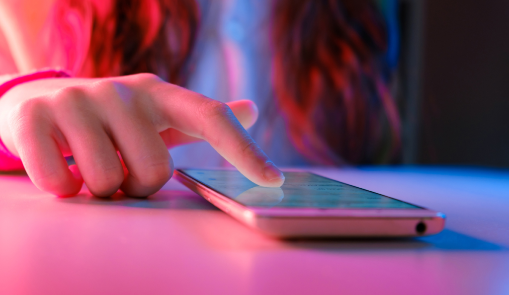 a finger touching a phone