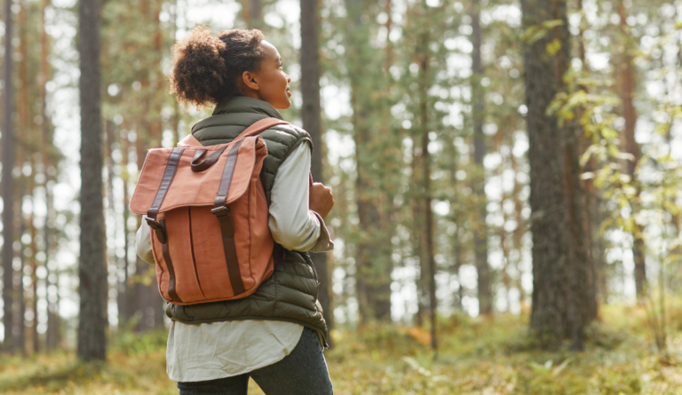 a woman with a backpack in the woods