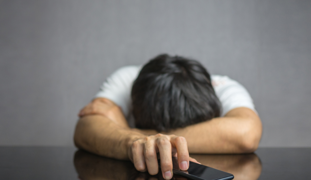 a man with his head on a phone