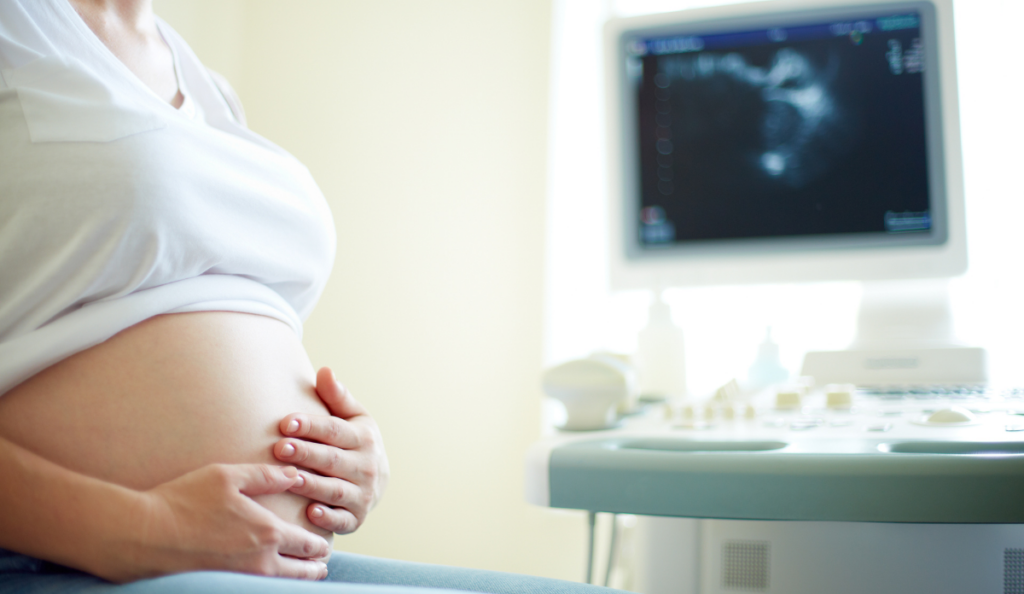 a pregnant woman holding her belly