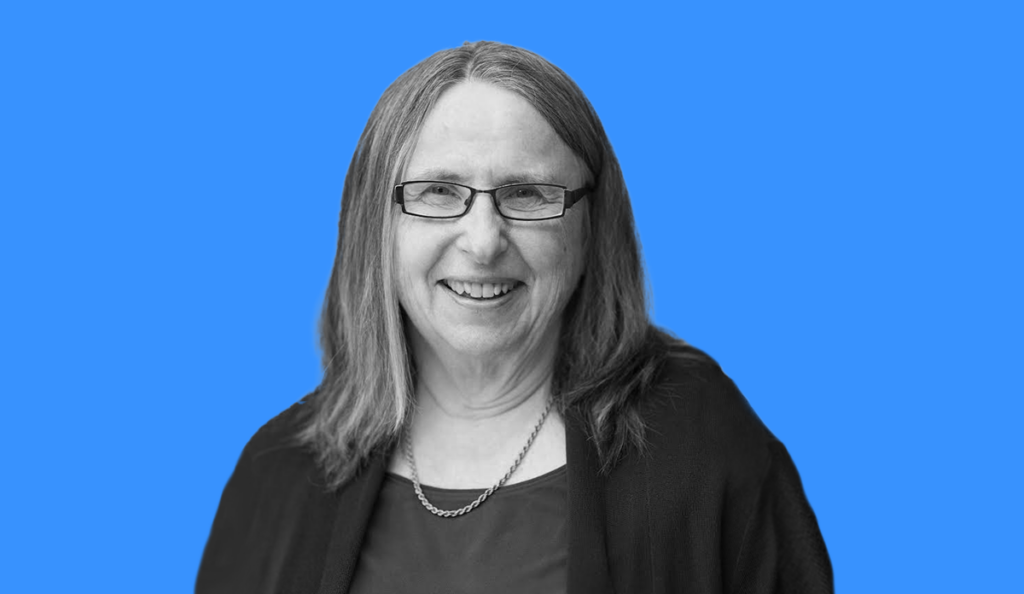 a woman wearing glasses and a necklace