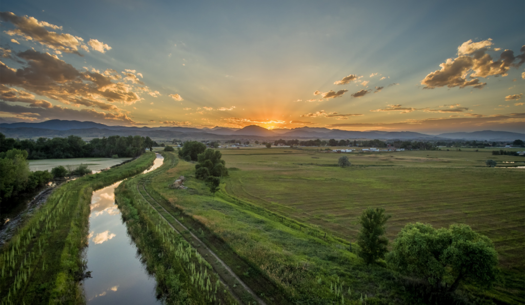 sun setting on rural land with groundwater