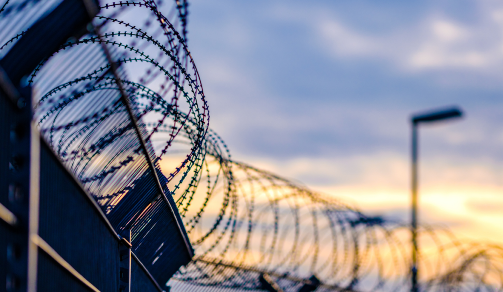 close up of barbed wire fence outside of a prison