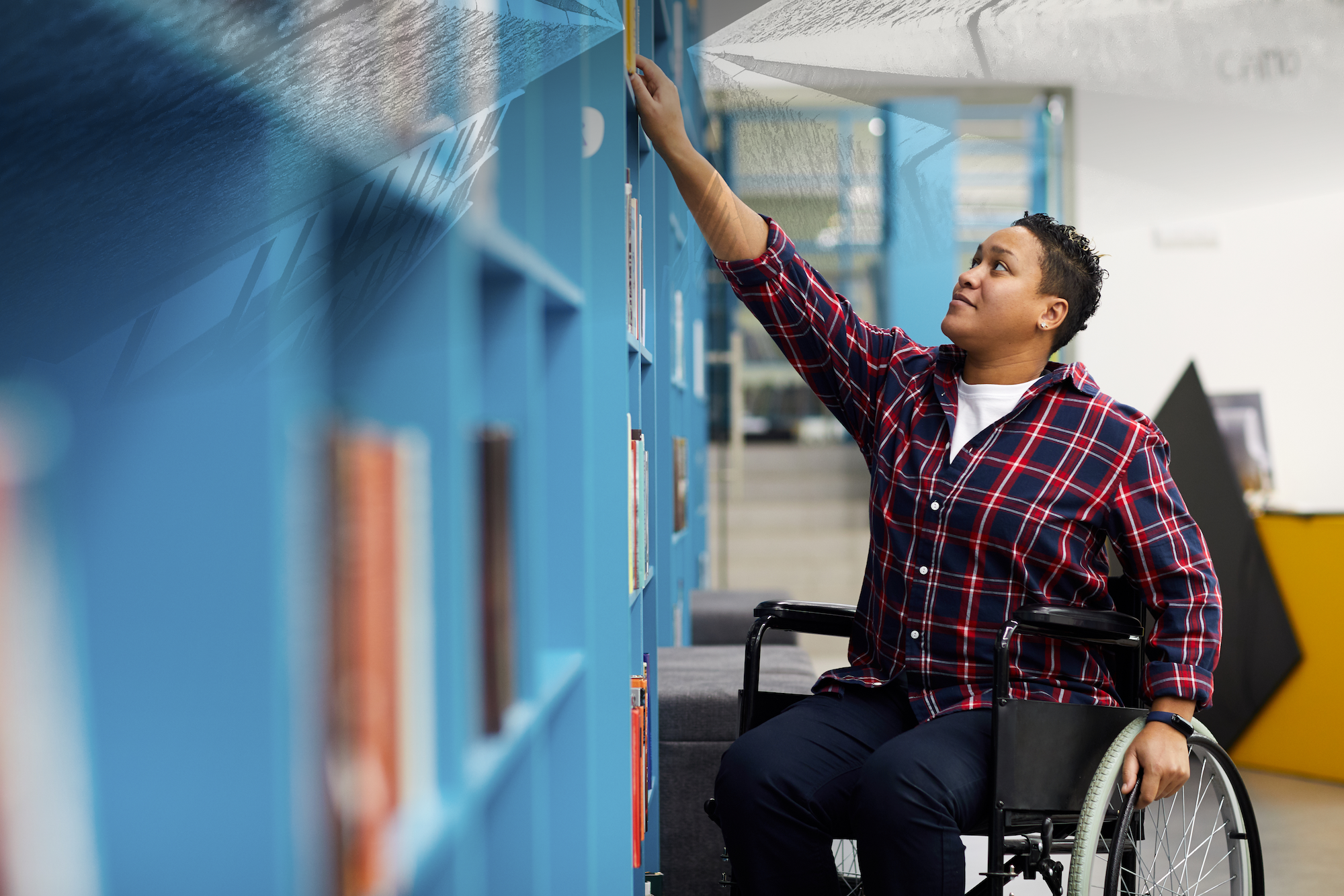 a person in a wheelchair touching a book shelf