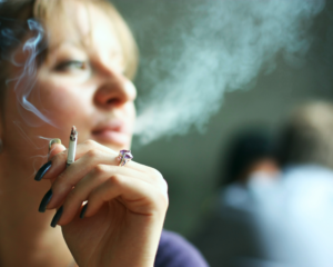 young woman smoking cigarette