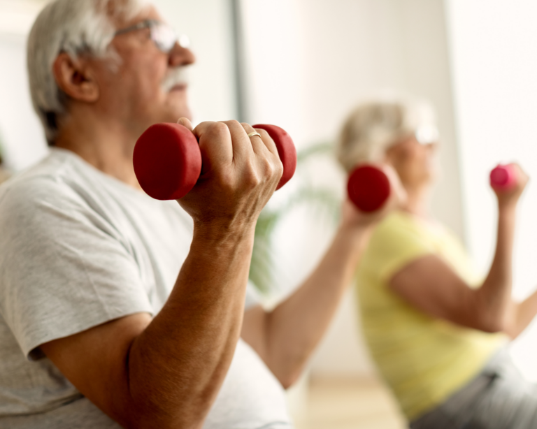 Close-up of older couple lifting weights