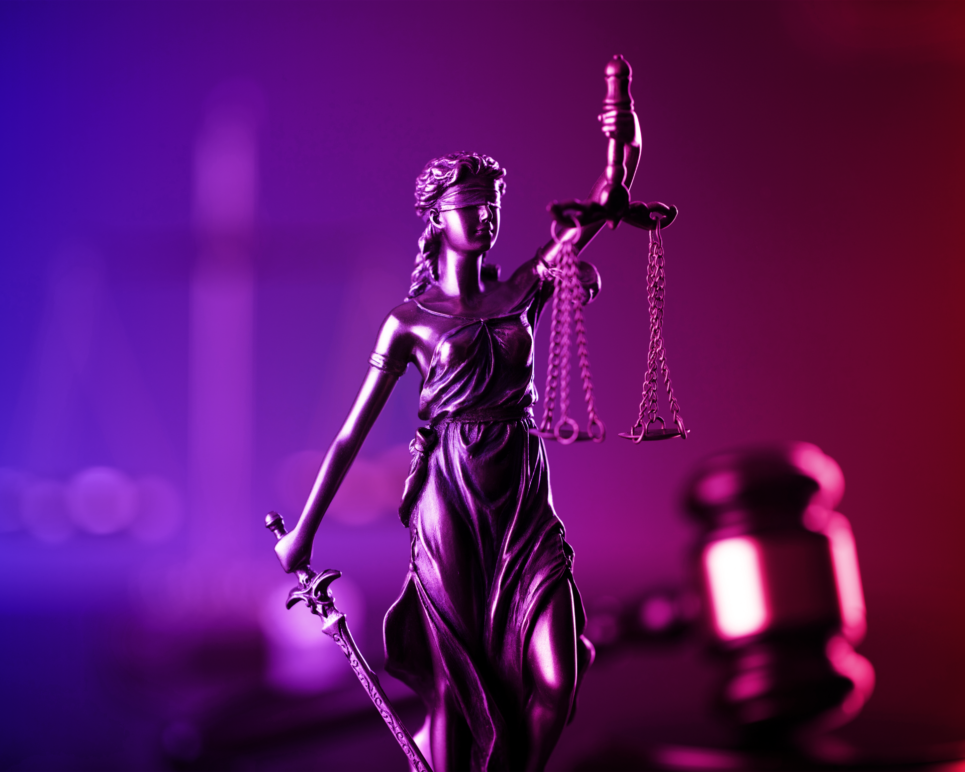 Lady of Justice statue with a red and blue gradient filter. criminal justice concept