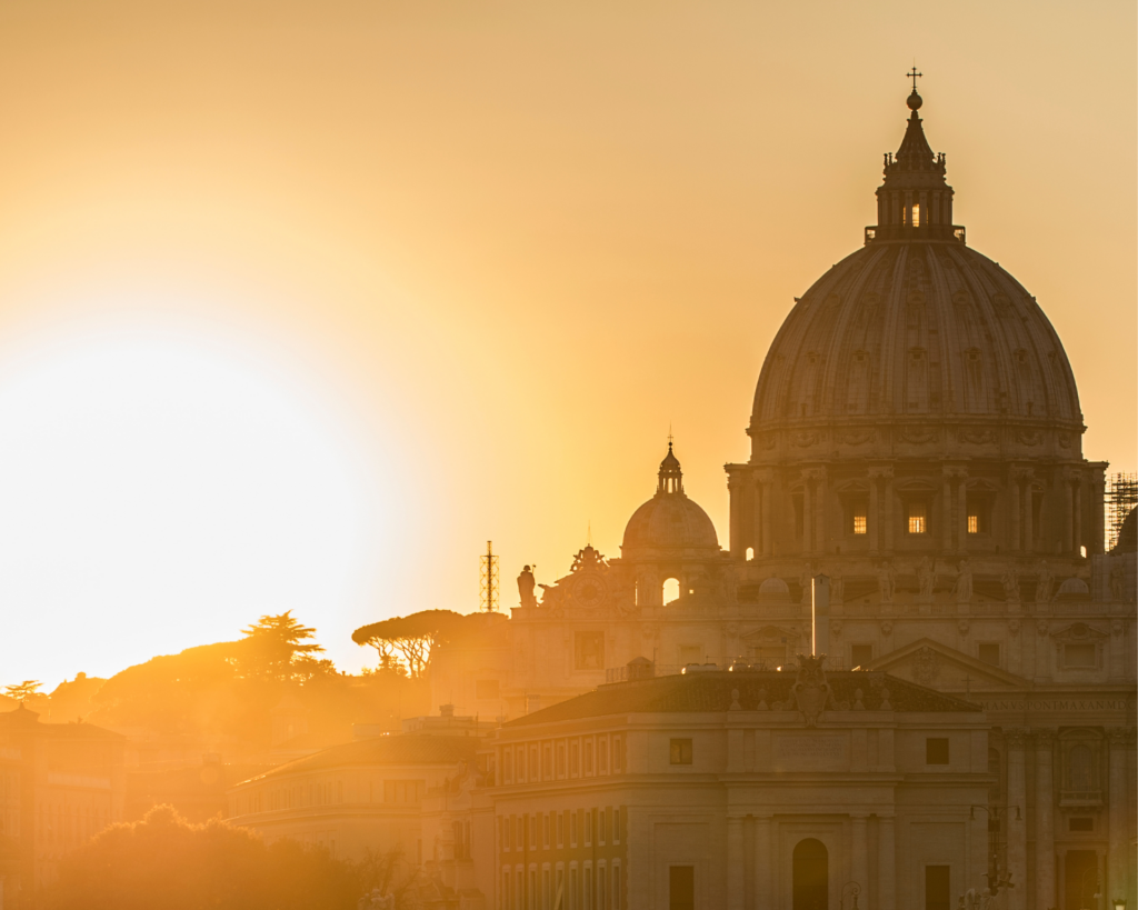 Vatican dome of Saint Peter Basilica (San Pietro) and Sant' Angelo Bridge over the Tiber river at sunset.