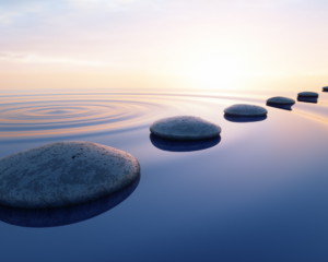 pebbles in a line across still water. meditation and spirituality concept