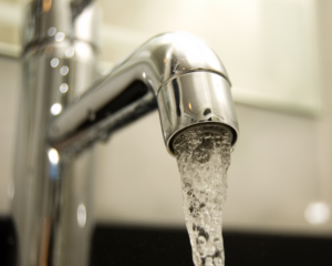 Close-up of fluoridated water coming out of the tap