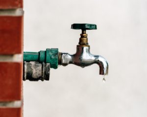 Back yard outdoor garden faucet with drop of water