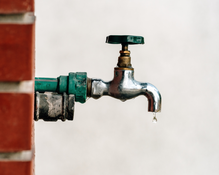 Back yard outdoor garden faucet with drop of water