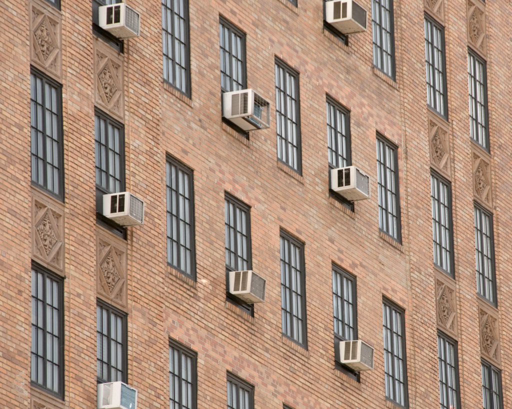 Exterior of urban building with windows and air conditioning units