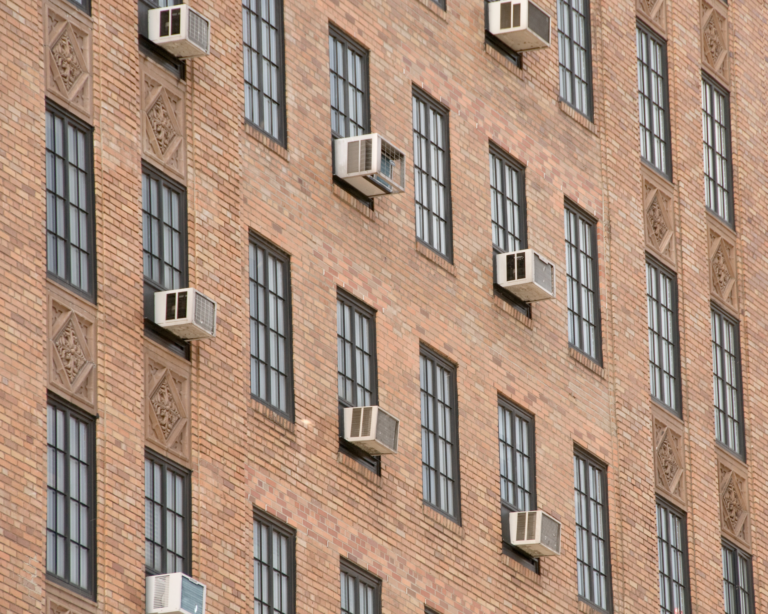 Exterior of urban building with windows and air conditioning units