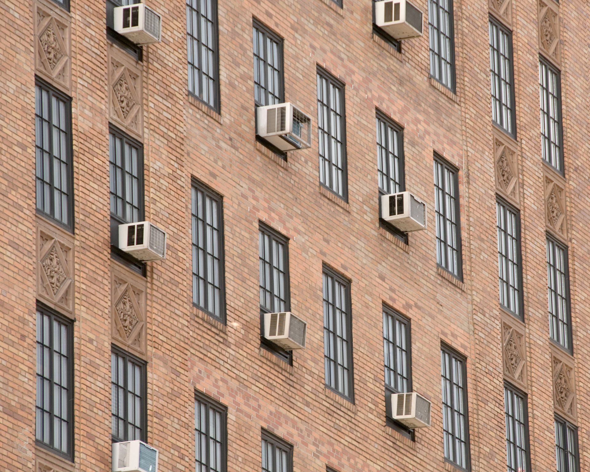 Exterior of urban building with windows and air conditioning units