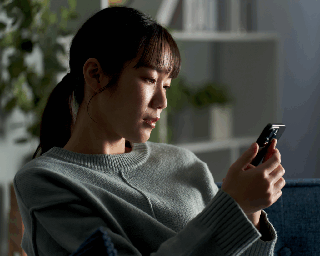 Portrait of a young woman scrolling on her phone with a concerned look on her face. Concept for finding health information on social media