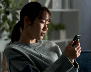 Portrait of a young woman scrolling on her phone with a concerned look on her face. Concept for finding health information on social media