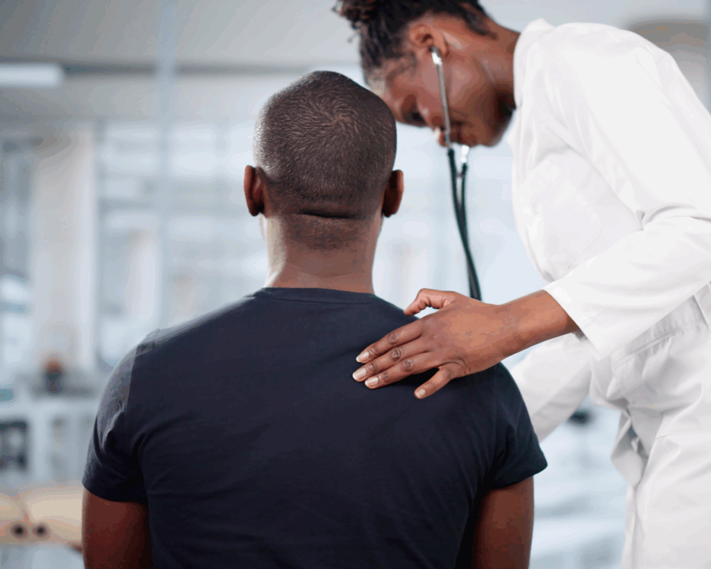 young Black man facing away from camera at a doctor's visit. cancer screening concept