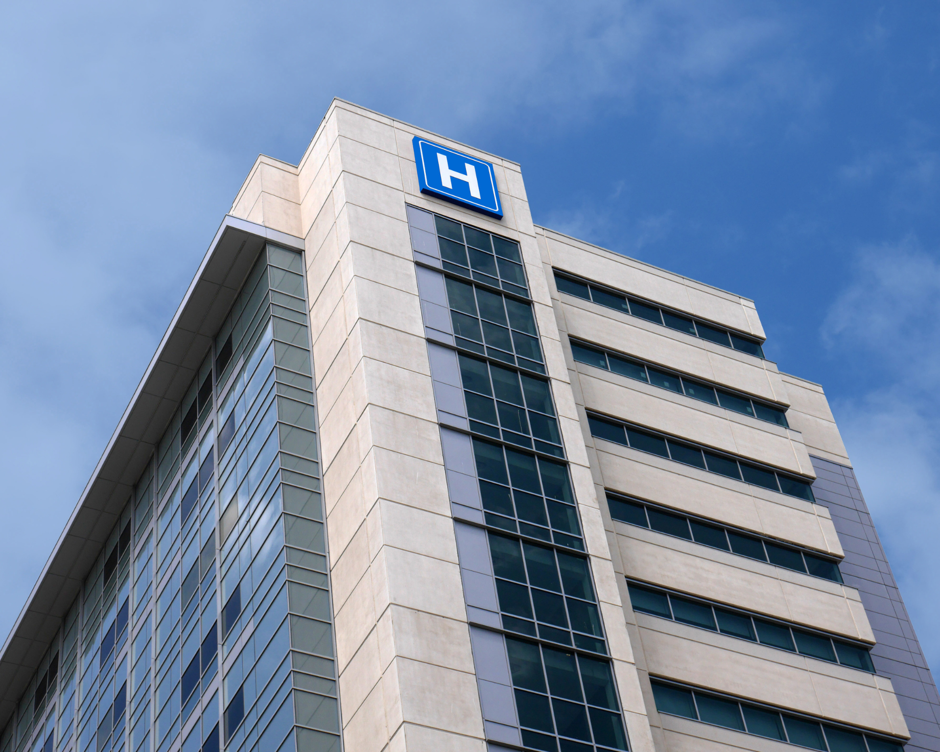 Building with a large H sign for "hospital"