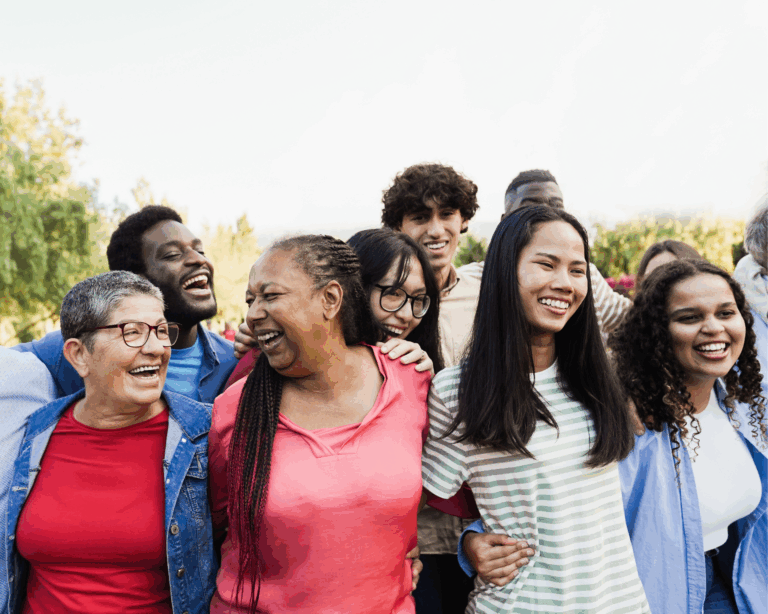 Group of multigenerational people smiling and laughing outdoors. Community empowerment concept