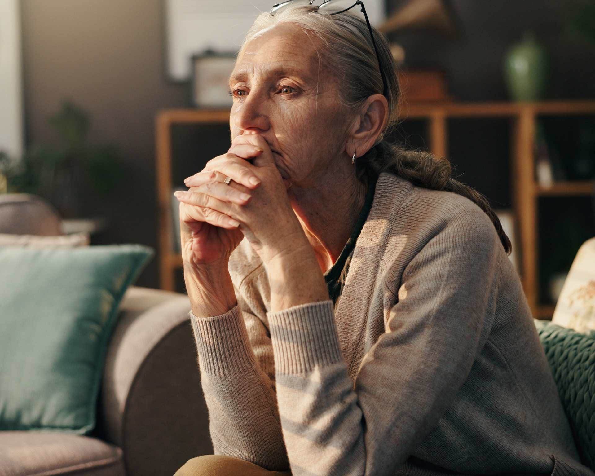 Portrait of an aging woman sitting on chair, somberly pondering life and belongings