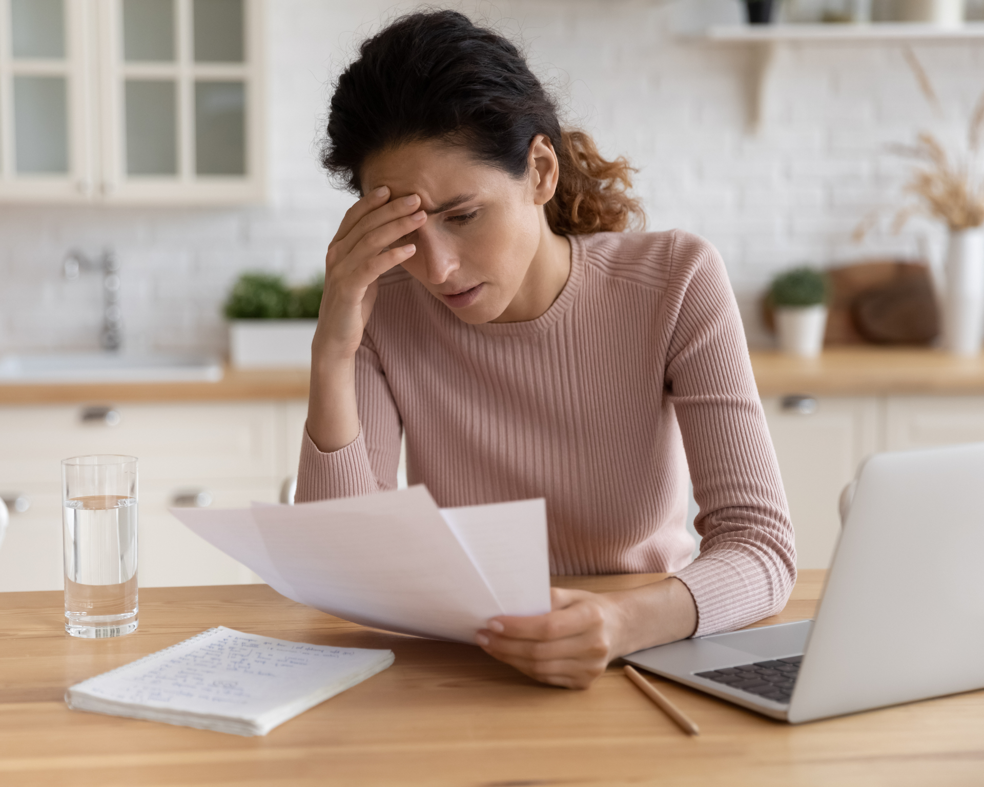 Worried, stressed young woman looking at health insurance bills