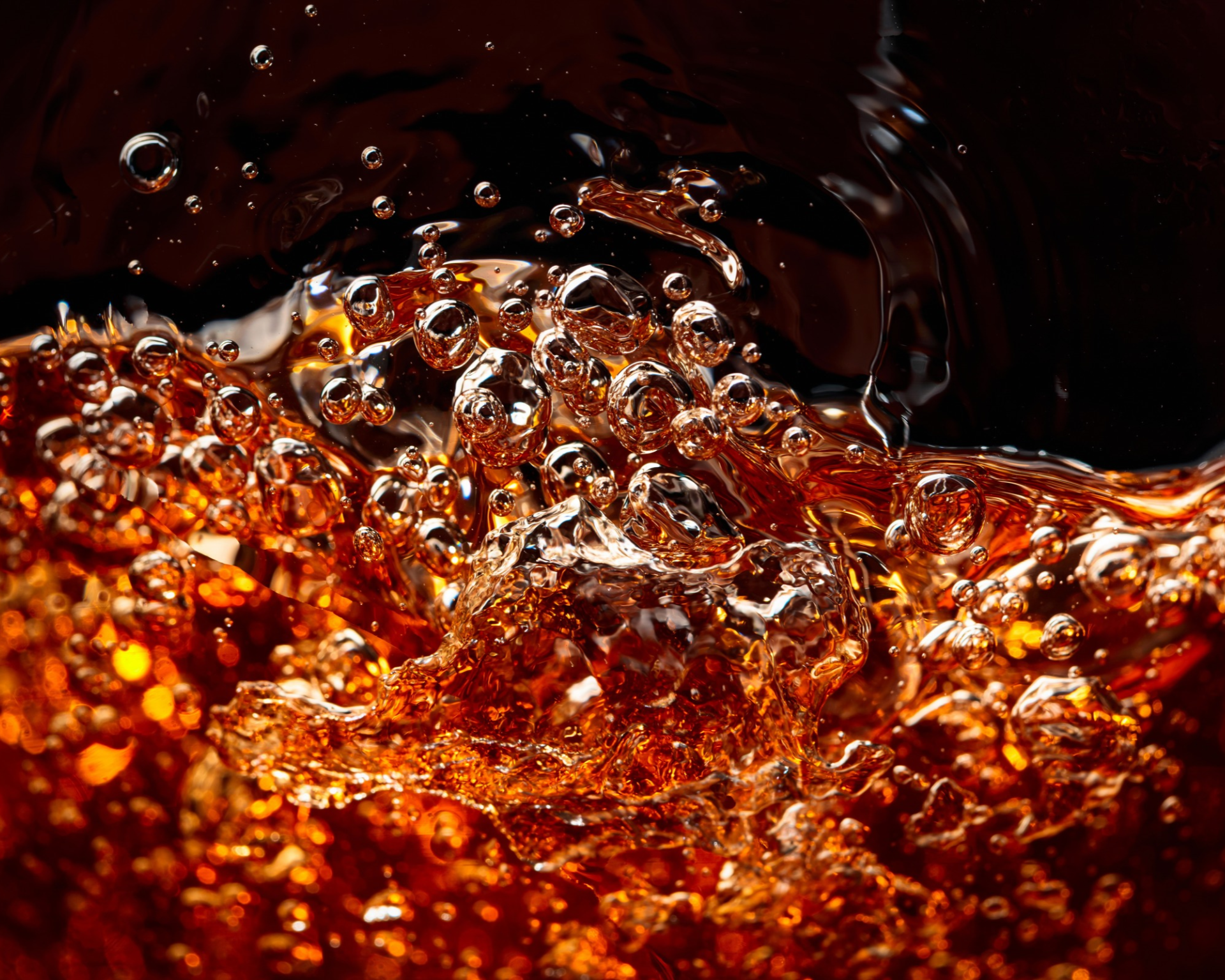 Macro shot of soda with carbonation bubbles. Sugary beverage and childhood obesity concept