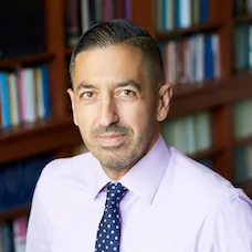 a man in a pink shirt and tie