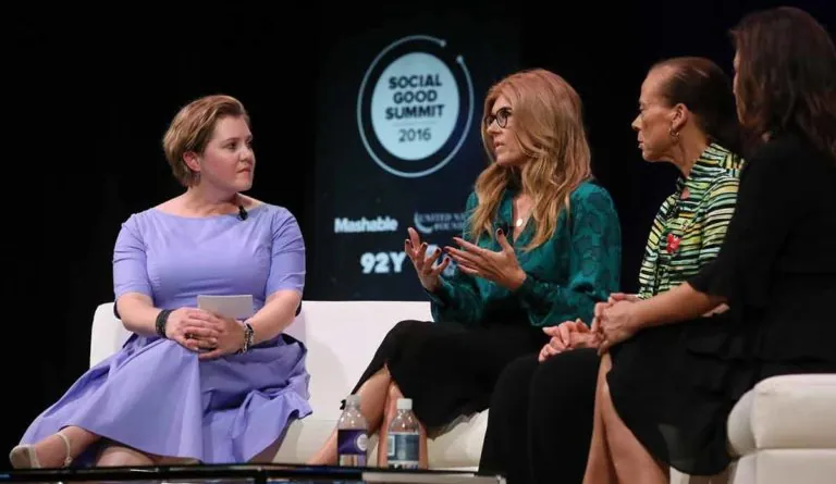 a group of women sitting on a white couch