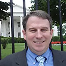 a man in a suit smiling