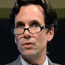 a man wearing glasses and a suit