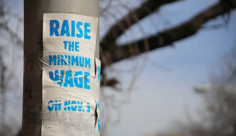 a white and blue sticker on a pole