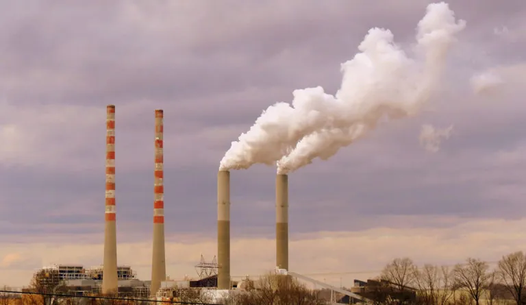smoke stacks of smoke coming out of a factory