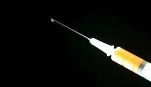 a needle with a drop of liquid
