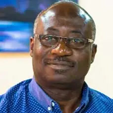a man wearing glasses and a blue shirt