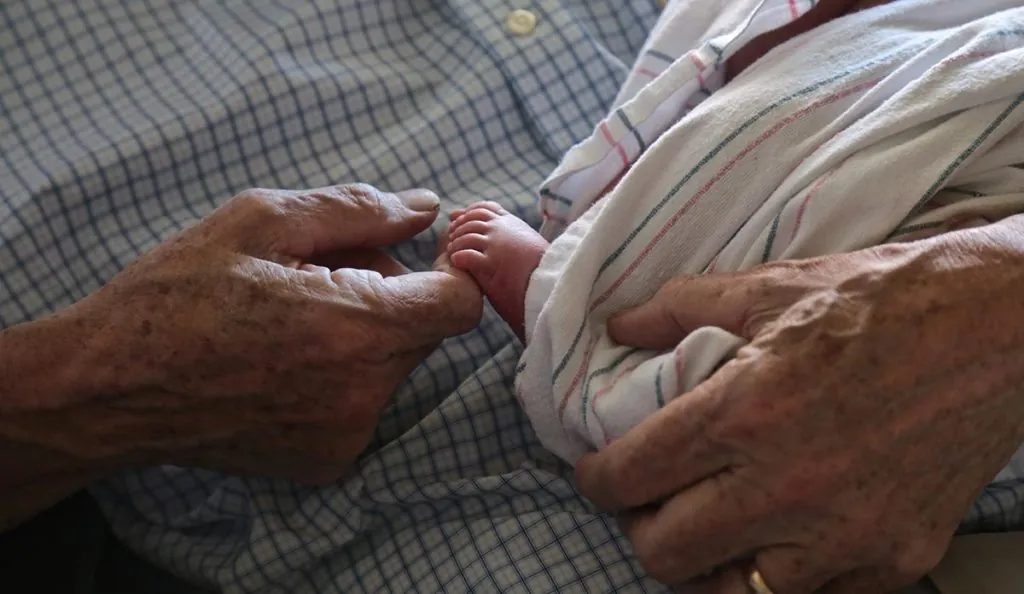 a baby's foot in a person's hand
