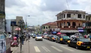 a busy street with cars and people