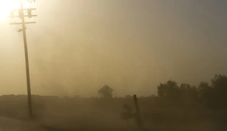 Landscape with dust in the air obscuring the sun during California drought